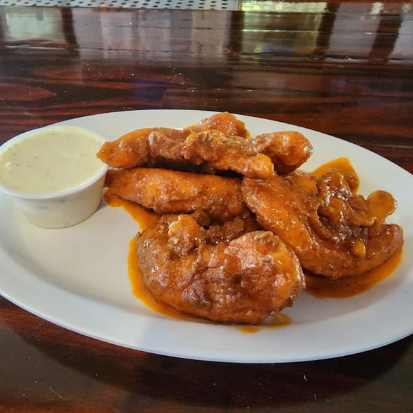 Snazzy's Hot Wings: a plate of saucy boneless wings with a side of ranch dressing.